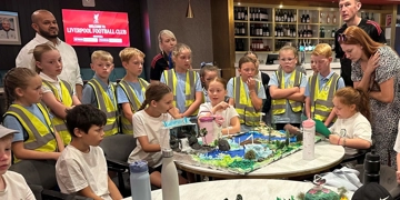 A group of Merseyside pupils displaying their models of perfect rivers at Anfield football stadium